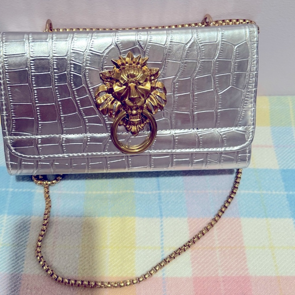 New luxurious showcase with a distinctive lion head motif, a silver bag